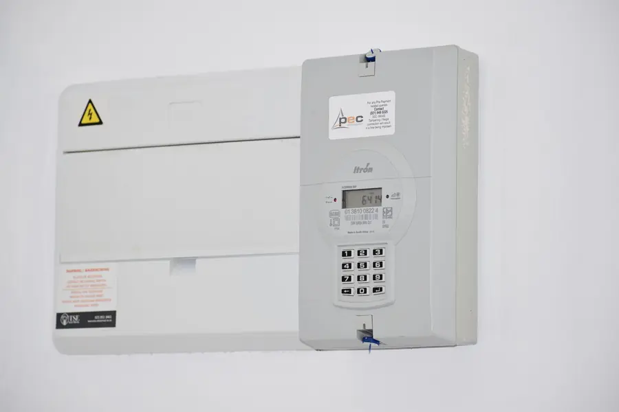 Business electricity meter and consumer unit on a white plant room wall, where solar payback starts