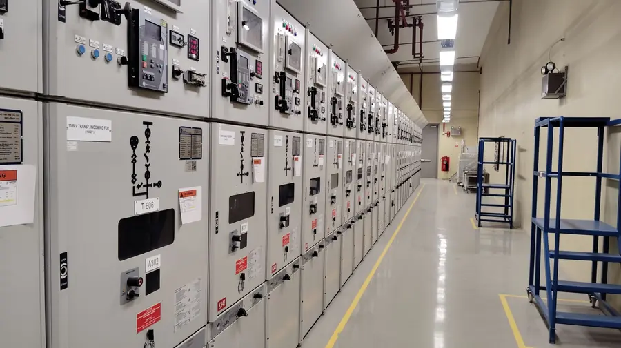 Low-voltage switchroom with rows of grey switchgear panels, where a site's agreed kVA capacity is measured
