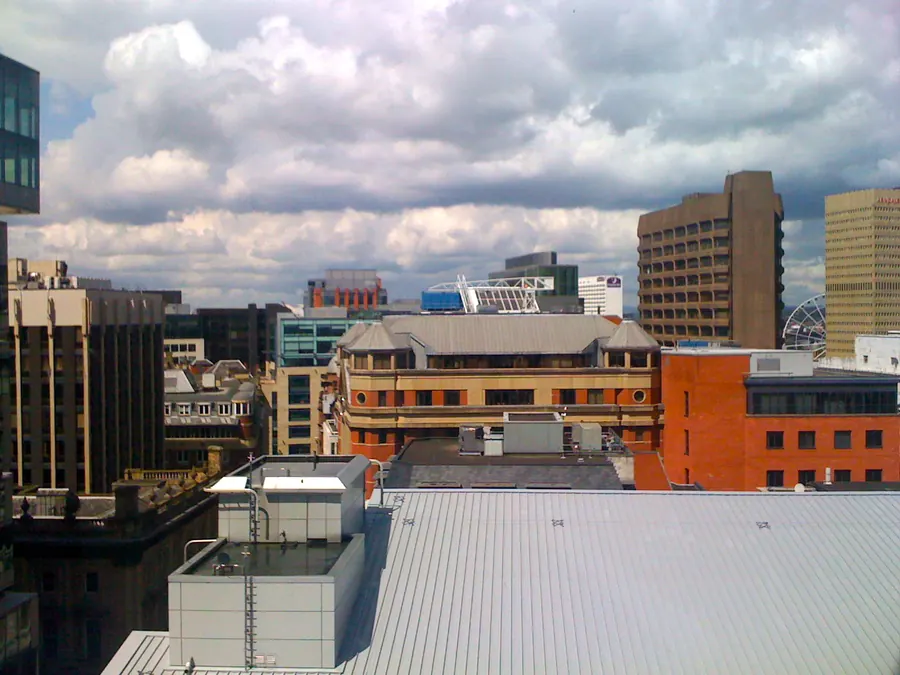 Flat commercial rooftops and office blocks across Manchester city centre seen from City Tower